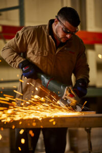 man using United Abrasives grinding wheel