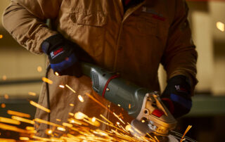 man using United Abrasives grinding wheel